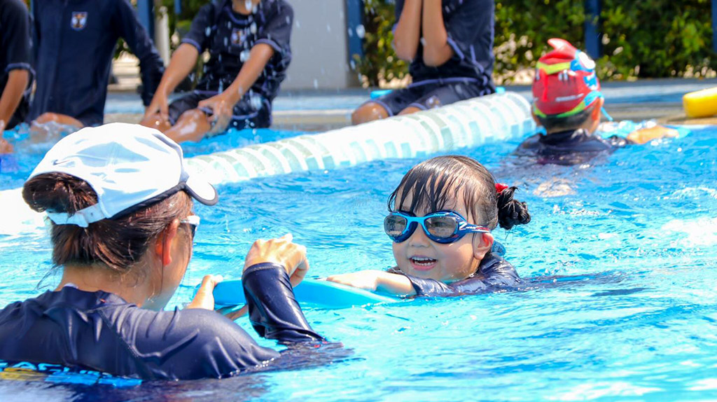 children having fun in a BEST learn to swim class, Bangkok