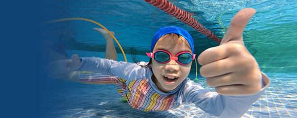 young girl under water during a learn to swim class at Bangkok Swim Academy
